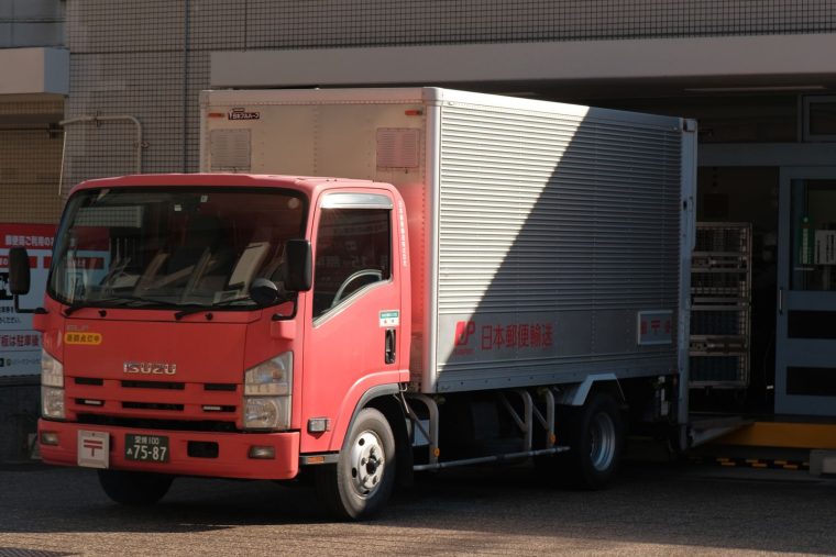 Delivery truck unloading goods at a warehouse