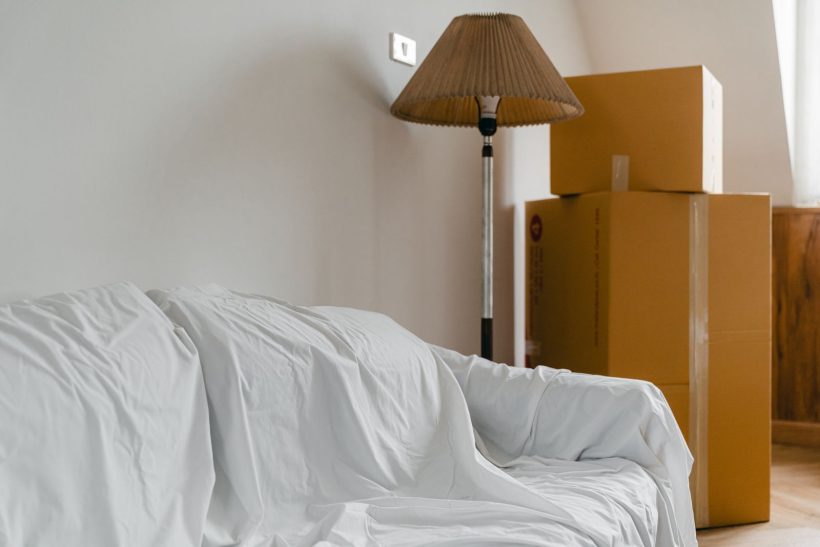 Packed cardboard boxes and wrapped furniture ready for a house move